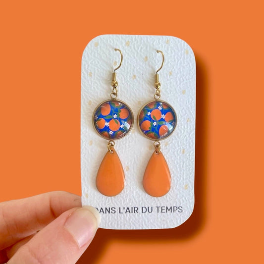 Boucles d'oreilles oranges sur fond bleu