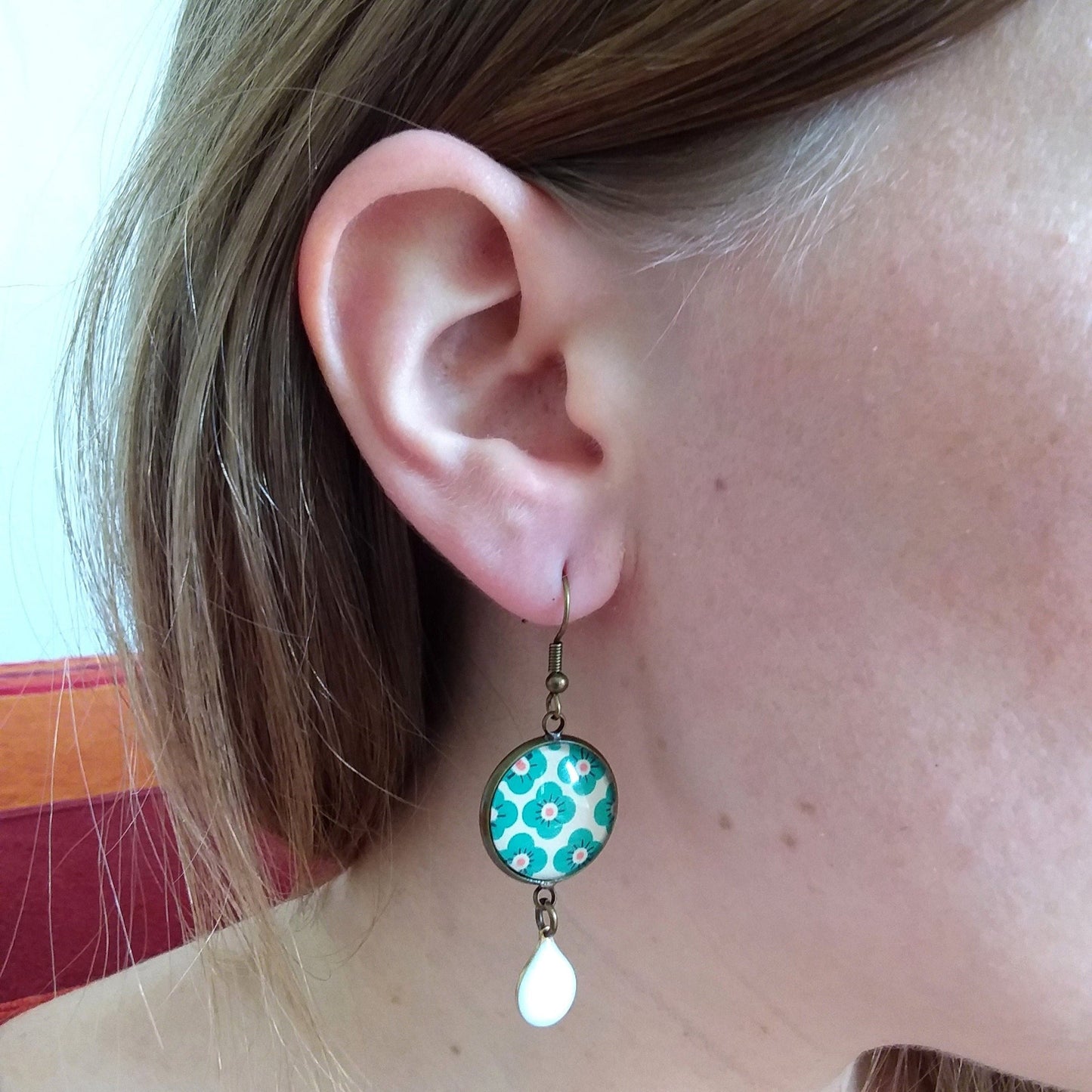 Green floral earrings and white enamel